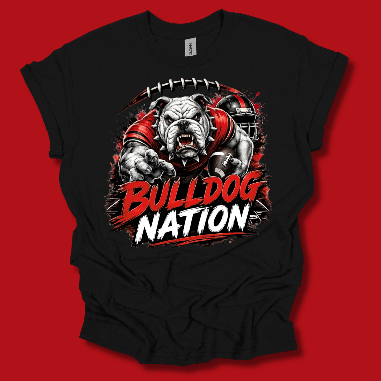 A black short-sleeve t-shirt with a graphic of a bulldog football player and the text 'BULLDOG NATION' in red and white, displayed against a solid red background.