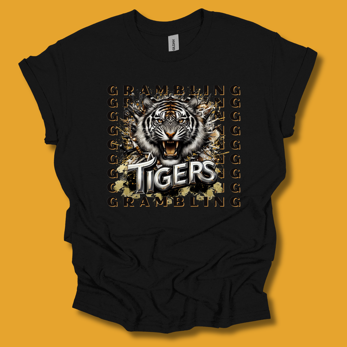 A black short-sleeve t-shirt with a large graphic print of a tiger head and the word 'TIGERS' in white, surrounded by gold 'GRAMBLING' text, displayed against a solid orange background.