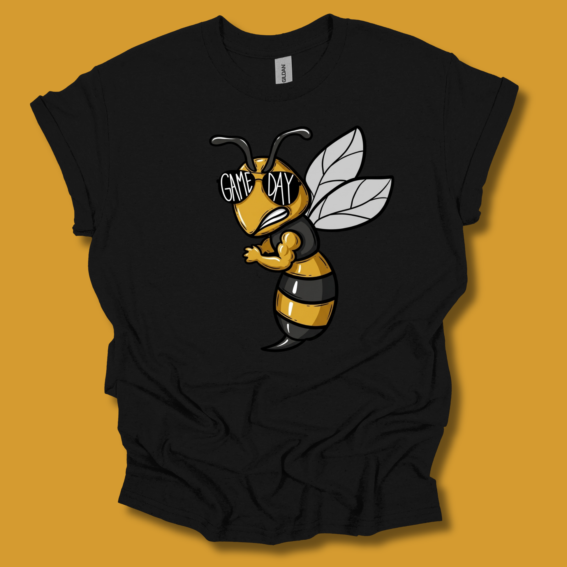 A black short-sleeve t-shirt with a cartoon bee graphic on the front. The bee is yellow and black striped with white wings and the text 'GAME DAY' written across its eyes.