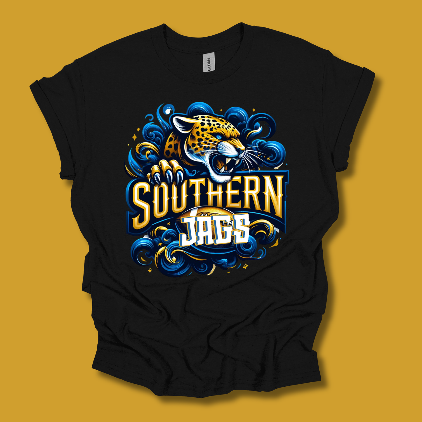 A black short-sleeve t-shirt with a graphic design of a roaring jaguar and the words 'SOUTHERN JAGS' in stylized yellow, blue, and white lettering, displayed against a solid mustard yellow background.