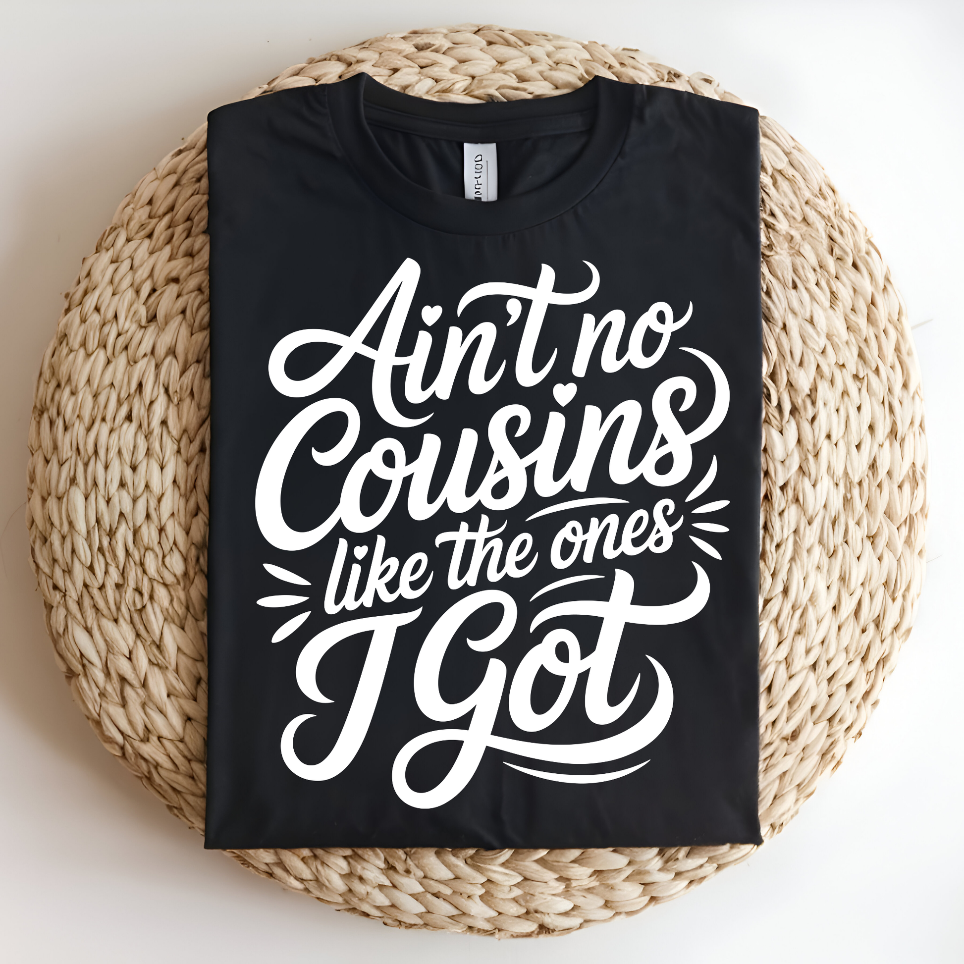 Black t-shirt with white text on a woven mat