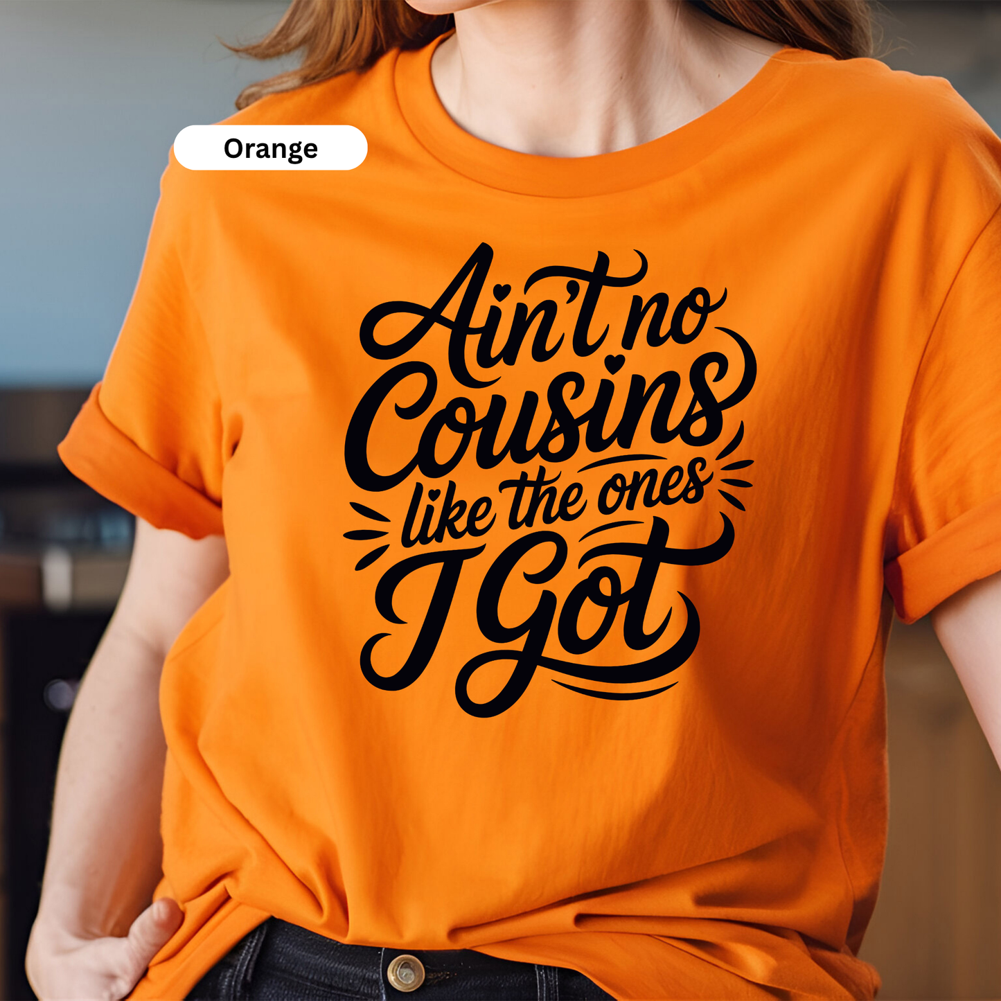 Person wearing an orange t-shirt with black text design.