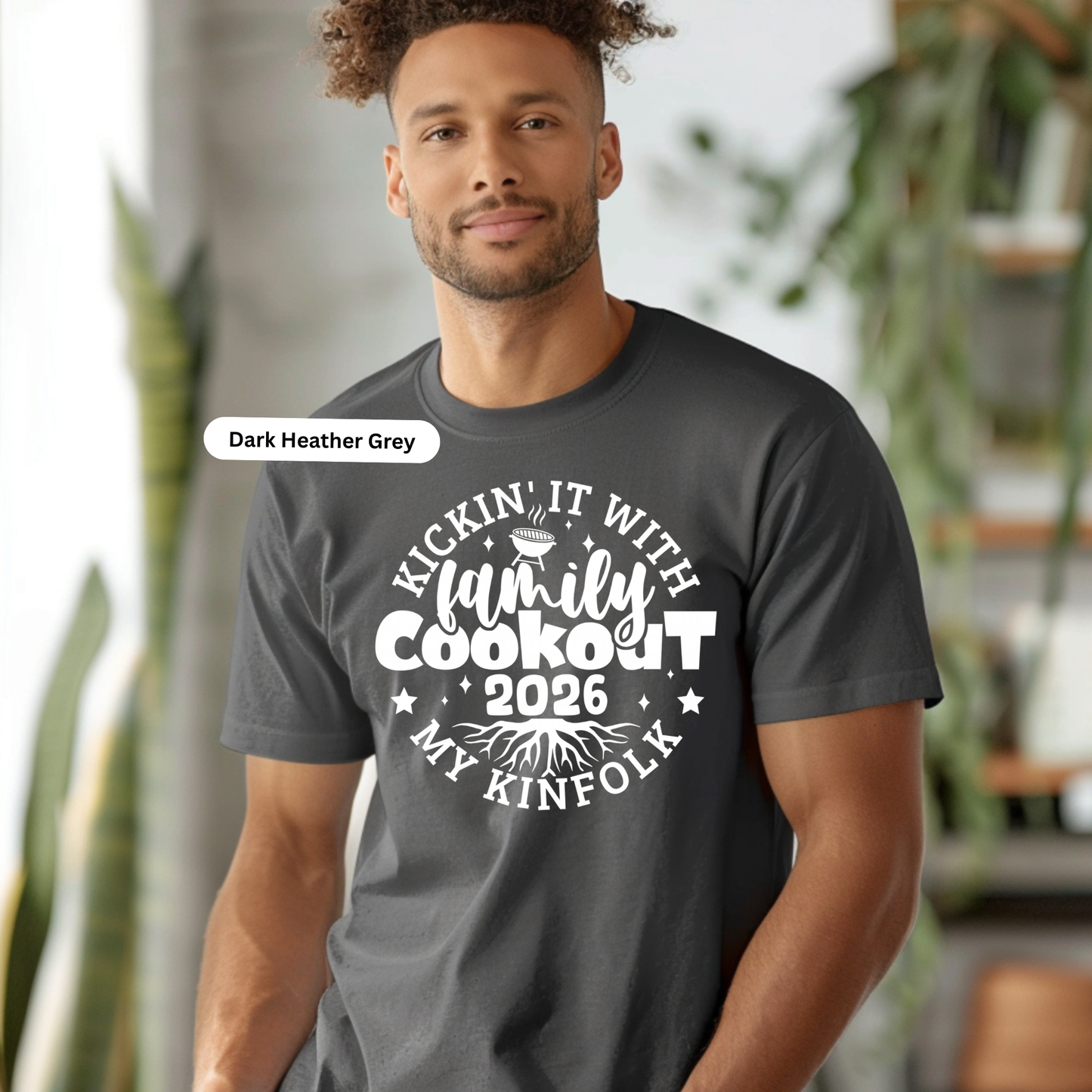 Man wearing a dark Heather Grey t-shirt with a family cookout event description.