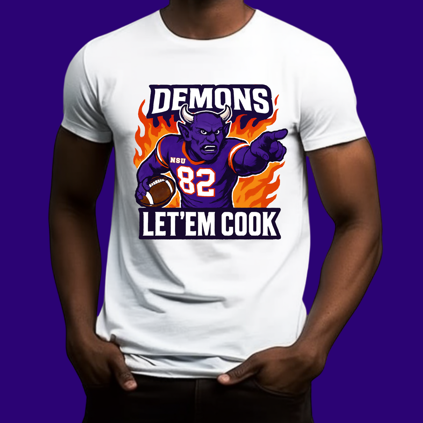 White t-shirt with a graphic of a demon holding a football and text 'DEMONS 82 LET'EM COOK' on a purple background.  Northwestern Demons Game Day T-Shirt - Demons  "Let'em Cook"  Football Tee