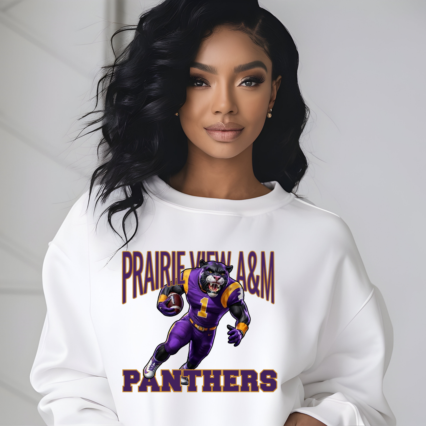 A woman wearing a white crewneck sweatshirt with a graphic of a purple and gold football player and the text 'PRAIRIE VIEW A&M PANTHERS'.