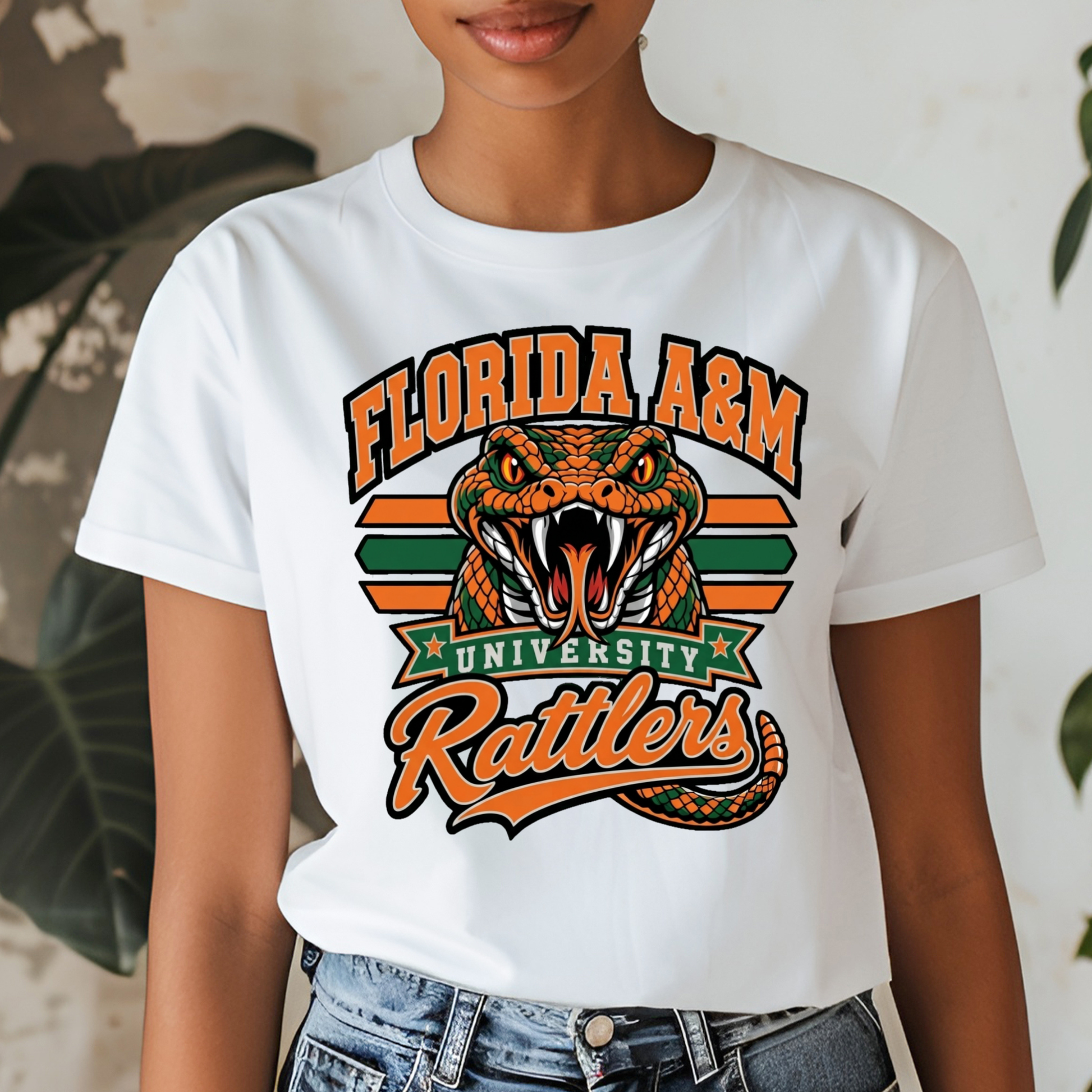 A woman wearing a white graphic t-shirt featuring the Florida A&M University Rattlers design with an orange and green alligator and the words 'FLORIDA A&M UNIVERSITY Rattlers'.