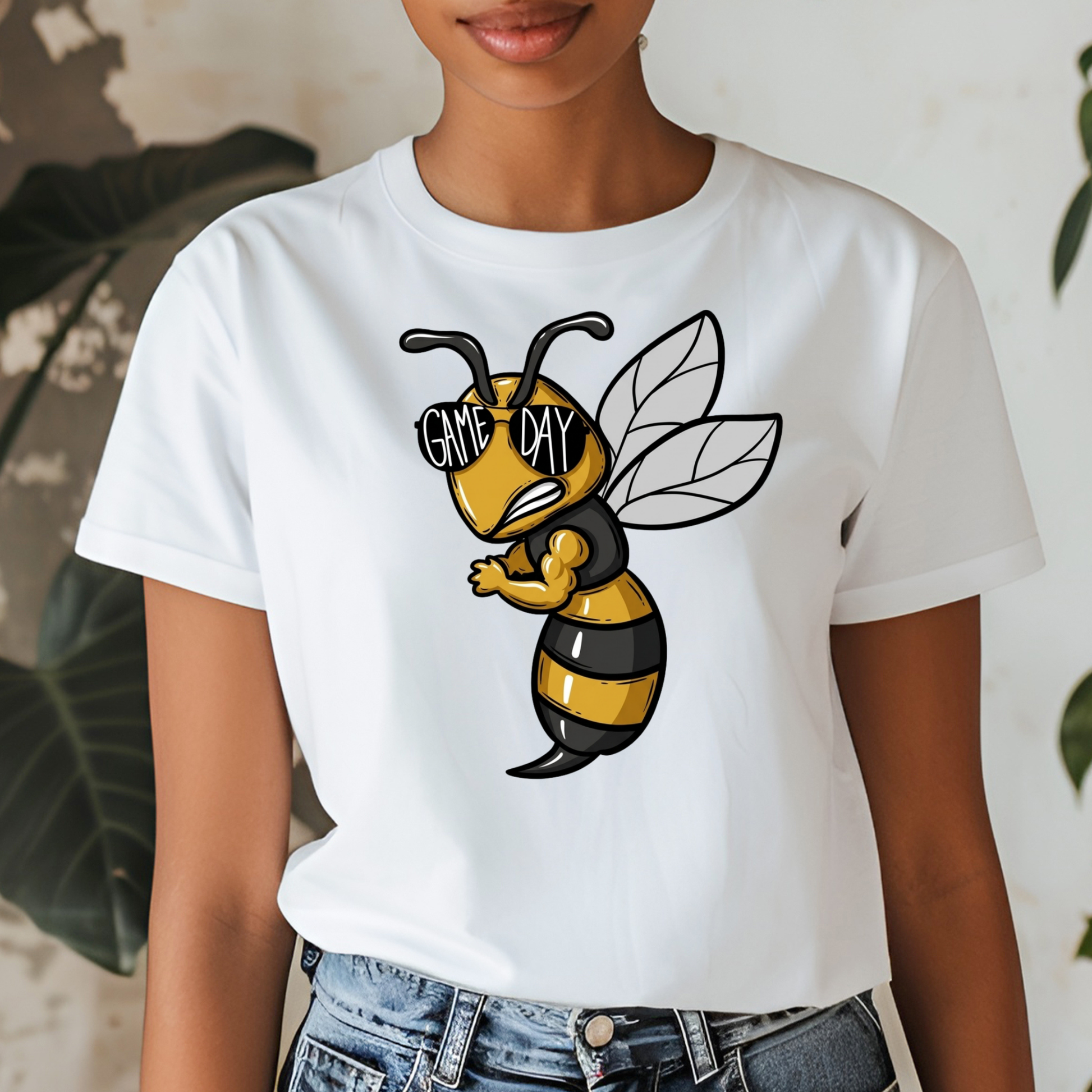 A woman wearing a white short-sleeve graphic t-shirt featuring a cartoon bee wearing black and yellow stripes and sunglasses with the text 'GIVE ME DAY'.