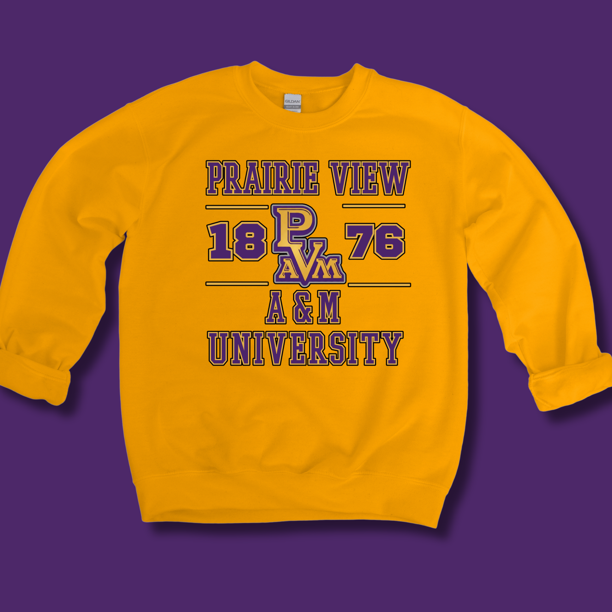 A yellow crewneck sweatshirt featuring a purple and gold graphic print that reads 'PRAIRIE VIEW 1876 A&M UNIVERSITY' with the 'PAM' logo in the center, displayed against a solid purple background.