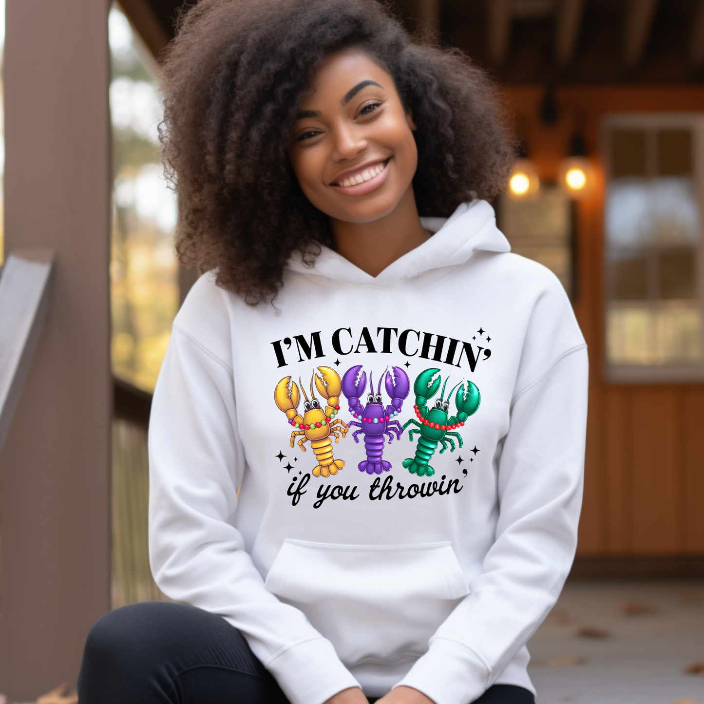 Person wearing a white hoodie with colorful lobster graphics and text.