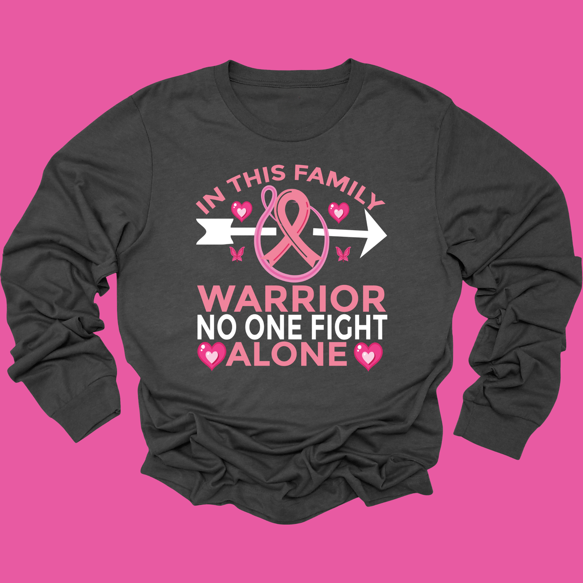 A dark charcoal gray long-sleeve t-shirt with a pink and white graphic design on the front. The graphic features a pink ribbon, hearts, butterflies, and the text 'IN THIS FAMILY WARRIOR NO ONE FIGHT ALONE'.
