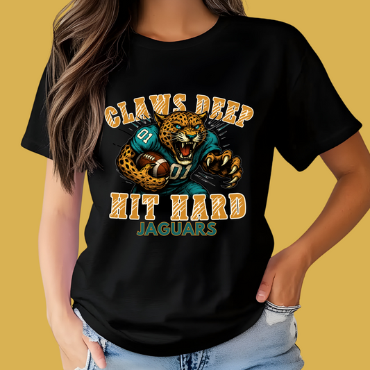 Person wearing a black t-shirt with a Jaguars graphic and text on a yellow background Jaguars Mascot Shirt – Fierce Jaguars "Claws Deep Hit Hard" Spirit Tee