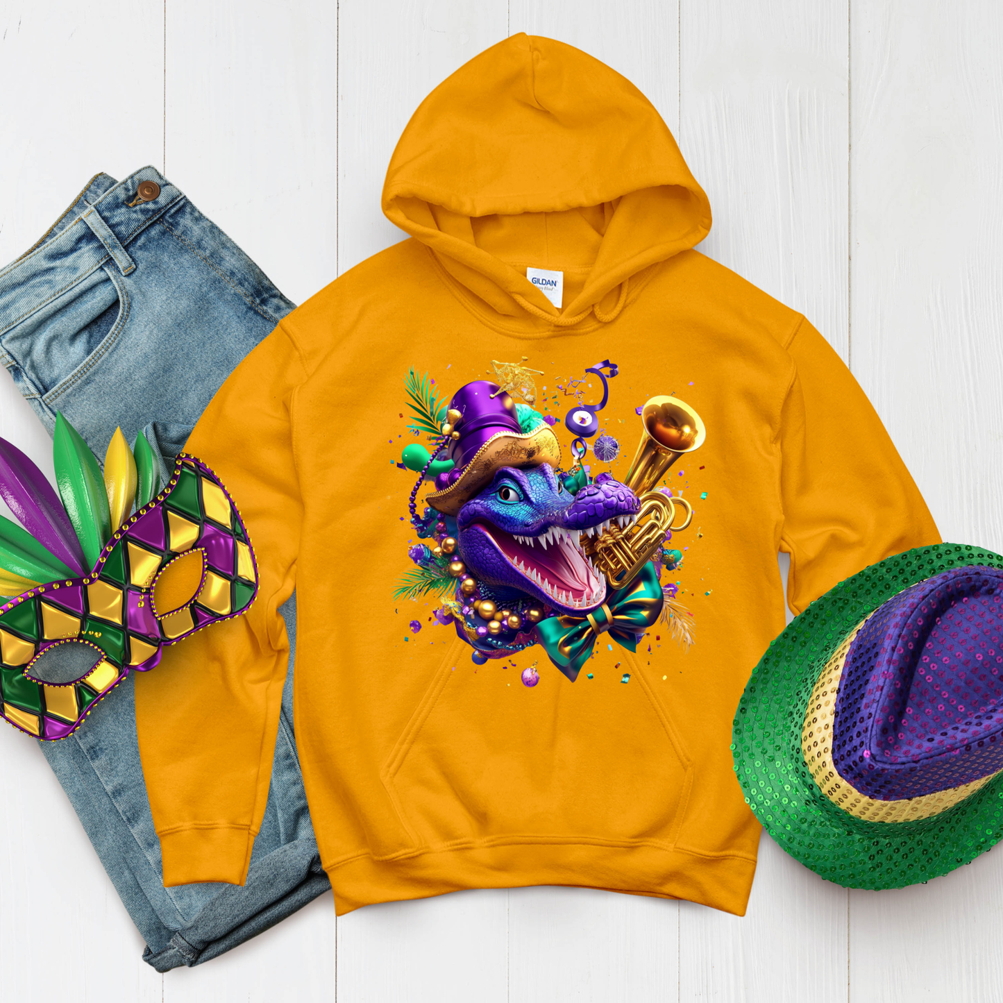 Yellow hoodie with a colorful dragon design, jeans, and Mardi Gras hat on a white background