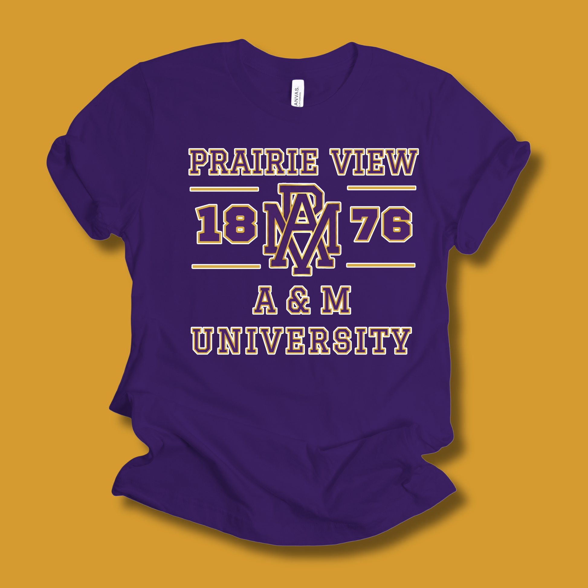 A purple short-sleeve t-shirt with a vintage-style collegiate graphic reading 'PRAIRIE VIEW 1876 A & M UNIVERSITY' in cream and gold, displayed against a solid mustard yellow background.