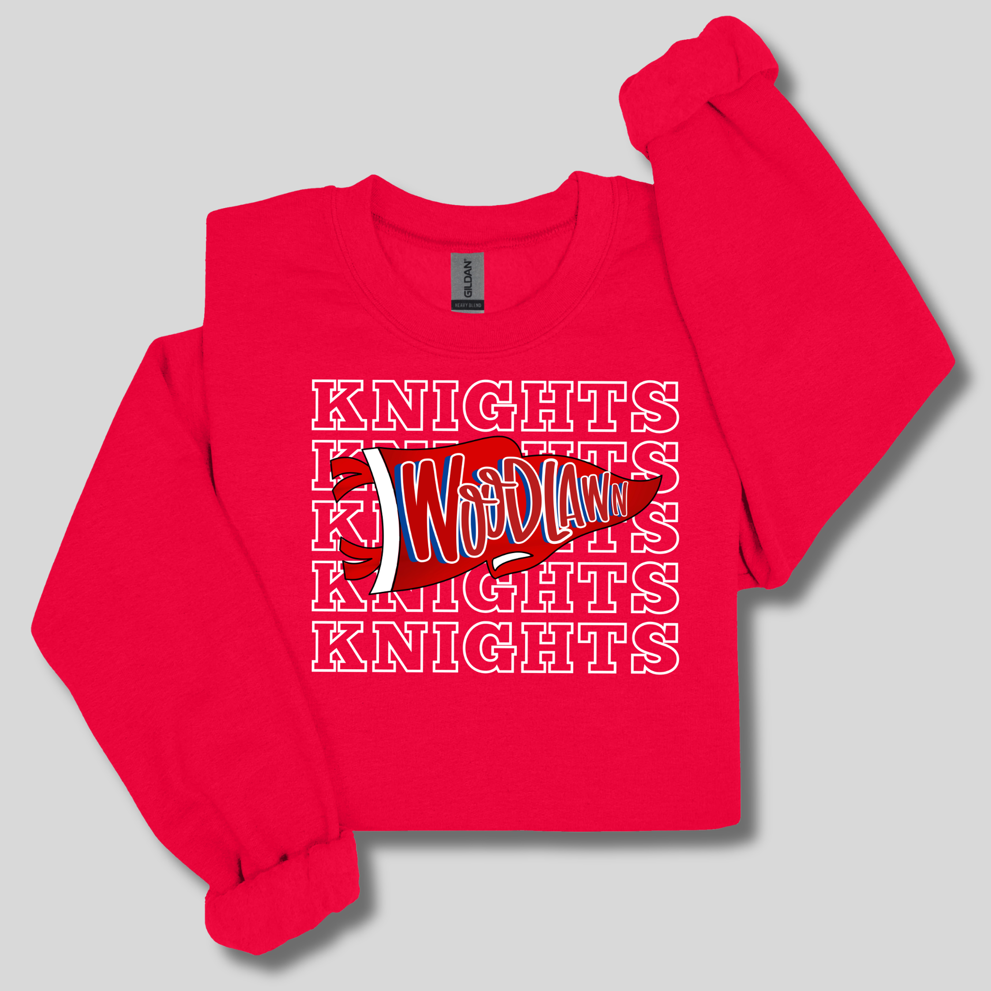 A bright red long-sleeve sweatshirt with a graphic print on the front. The design features the word 'Woodland' in a stylized red, white, and blue font layered over a repeating white outline text pattern that reads 'KNIGHTS'.