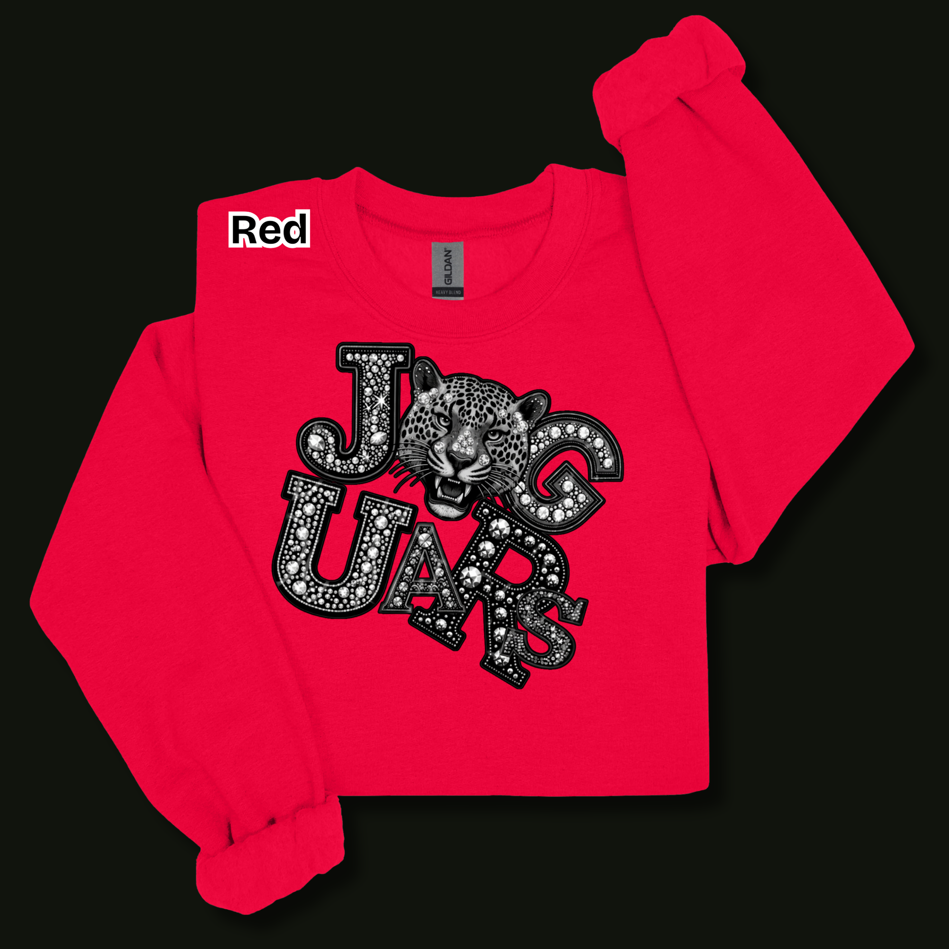 A bright red sweatshirt with a graphic print of a jaguar and the word 'JAGUARS' in a black-and-white patterned font. A small white label with the word 'Red' is visible near the collar.