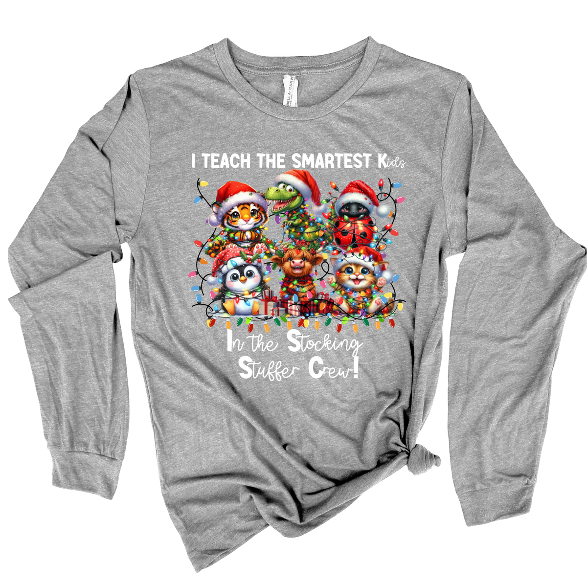 A heather gray long-sleeve t-shirt with a festive Christmas graphic of cartoon animals wearing Santa hats and holiday lights, with the text 'I TEACH THE SMARTEST Kids In the Stocking Stuffer Crew!'.