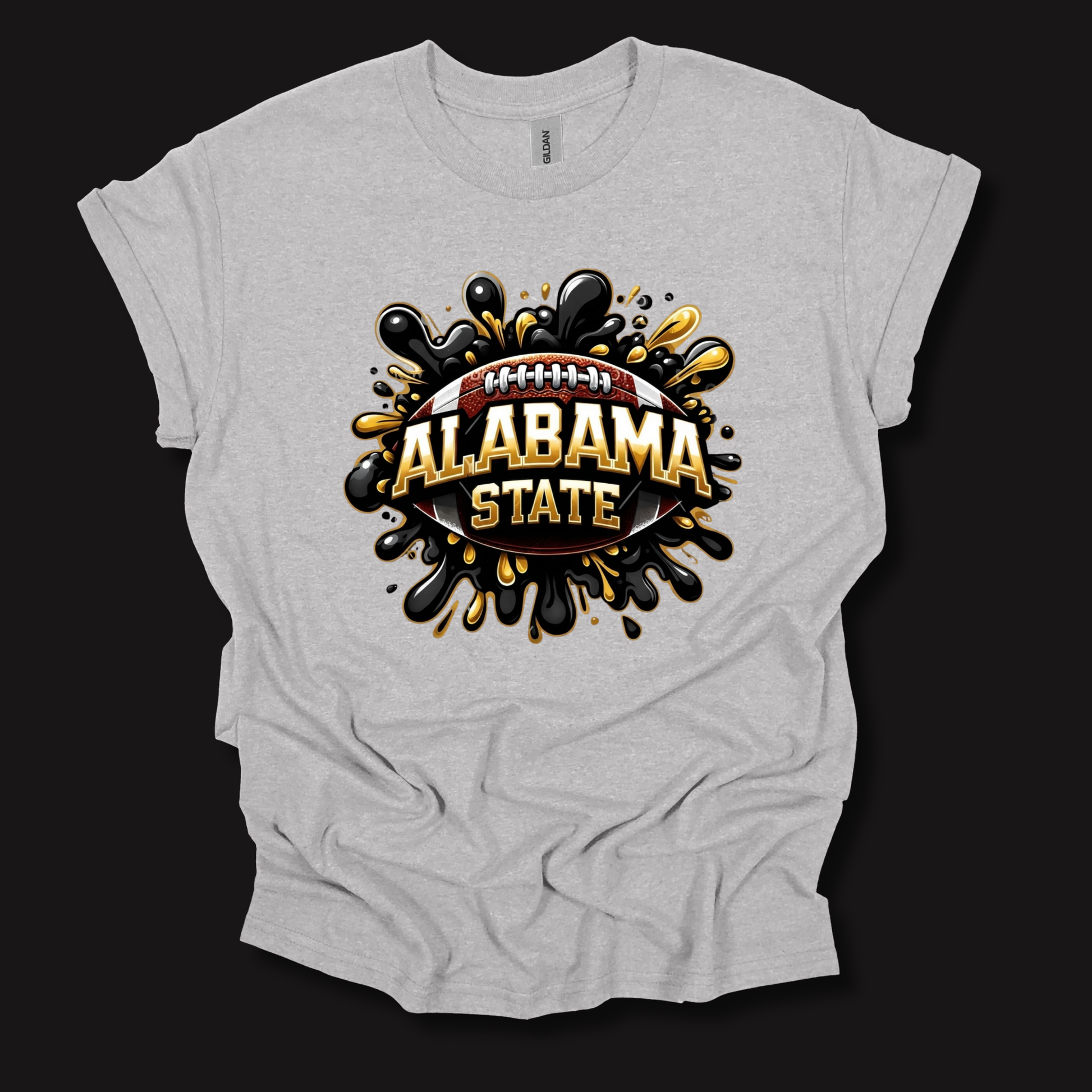 A light heather gray t-shirt with a graphic print of an Alabama State football design, featuring black and gold paint splatters and the text 'ALABAMA STATE' on a dark background.