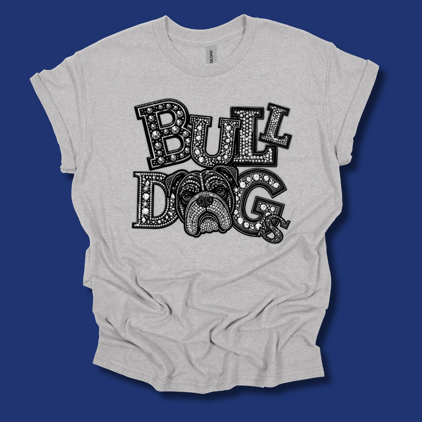 A light heather gray t-shirt with a black graphic reading 'BULL DOG' in decorative block letters, laid flat against a solid dark blue background.