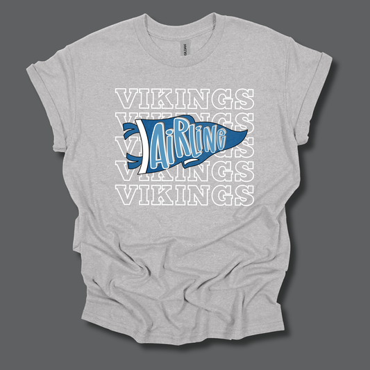 A light heather gray t-shirt with a graphic design featuring the word 'VIKINGS' repeated in white outline text and a blue pennant shape in the center with 'AirRug' written in white script.