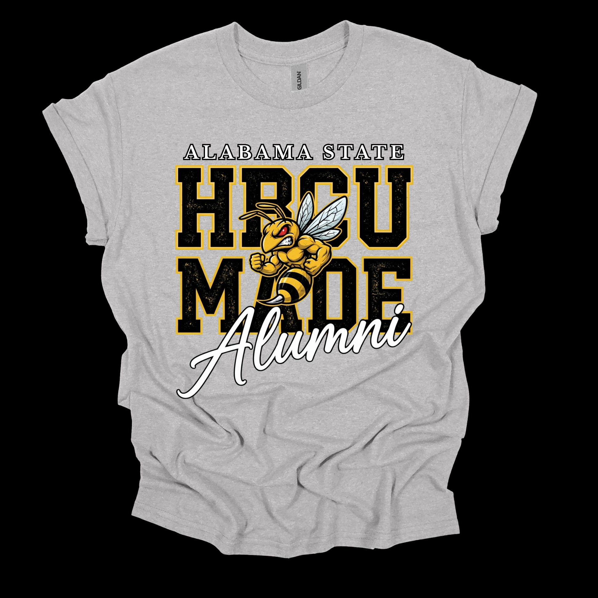 A light heather gray t-shirt featuring a graphic design that reads 'ALABAMA STATE HBCU MADE ALUMNI' with a cartoon bee mascot, shown against a solid black background.