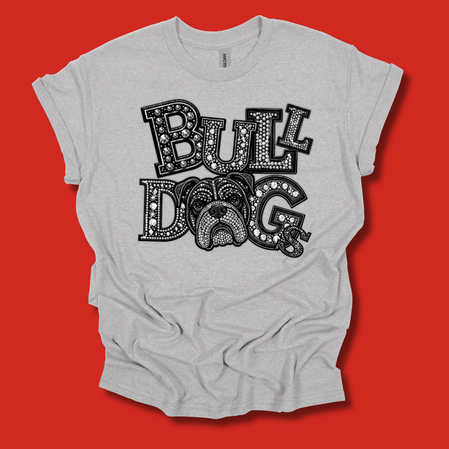 A light heather gray t-shirt with a graphic print reading 'BULL DOG' in black dotted lettering, featuring a bulldog face integrated into the letter 'O', displayed against a solid red background.