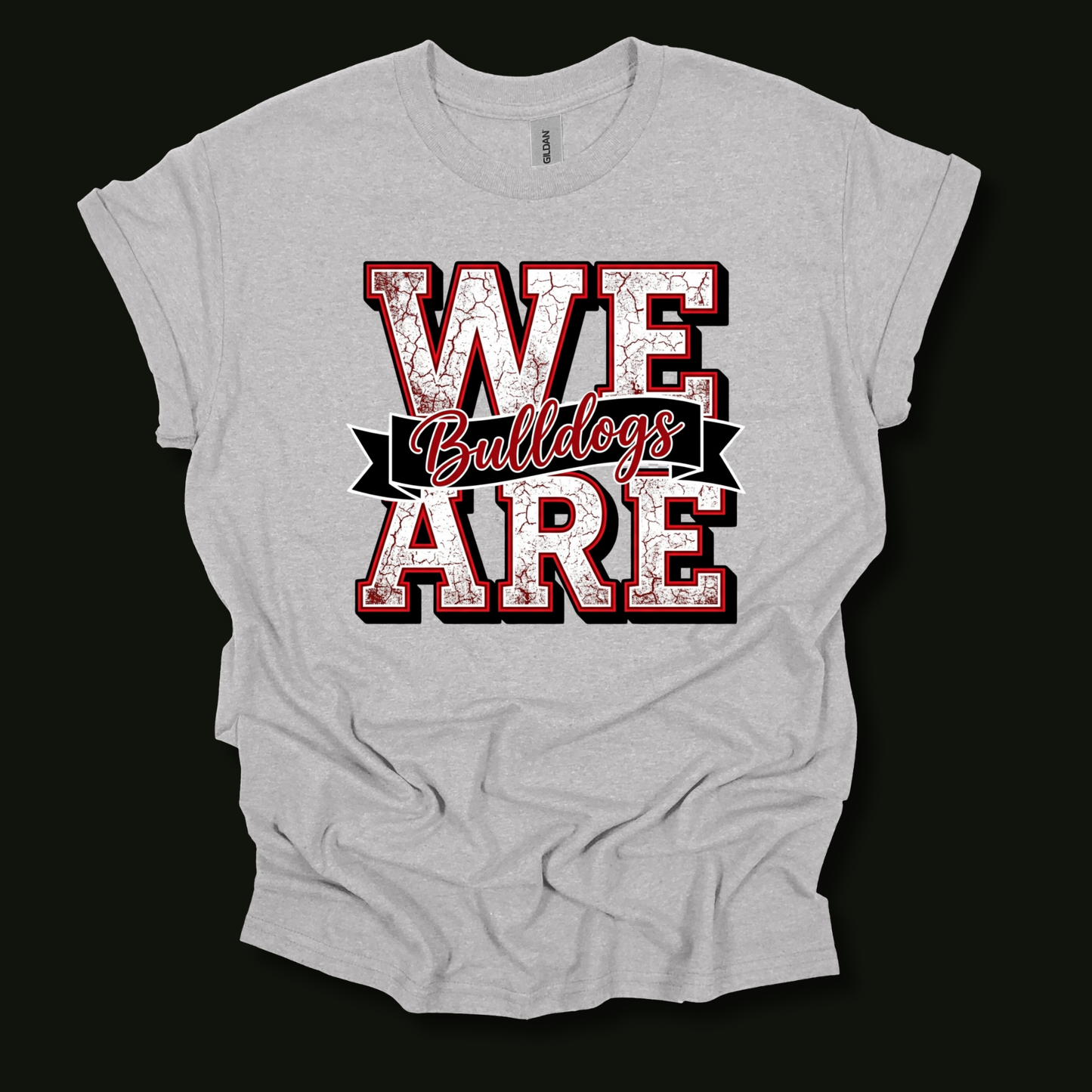 A light heather gray t-shirt with a distressed graphic reading 'WE ARE Bulldogs' in red and white, displayed against a solid black background.