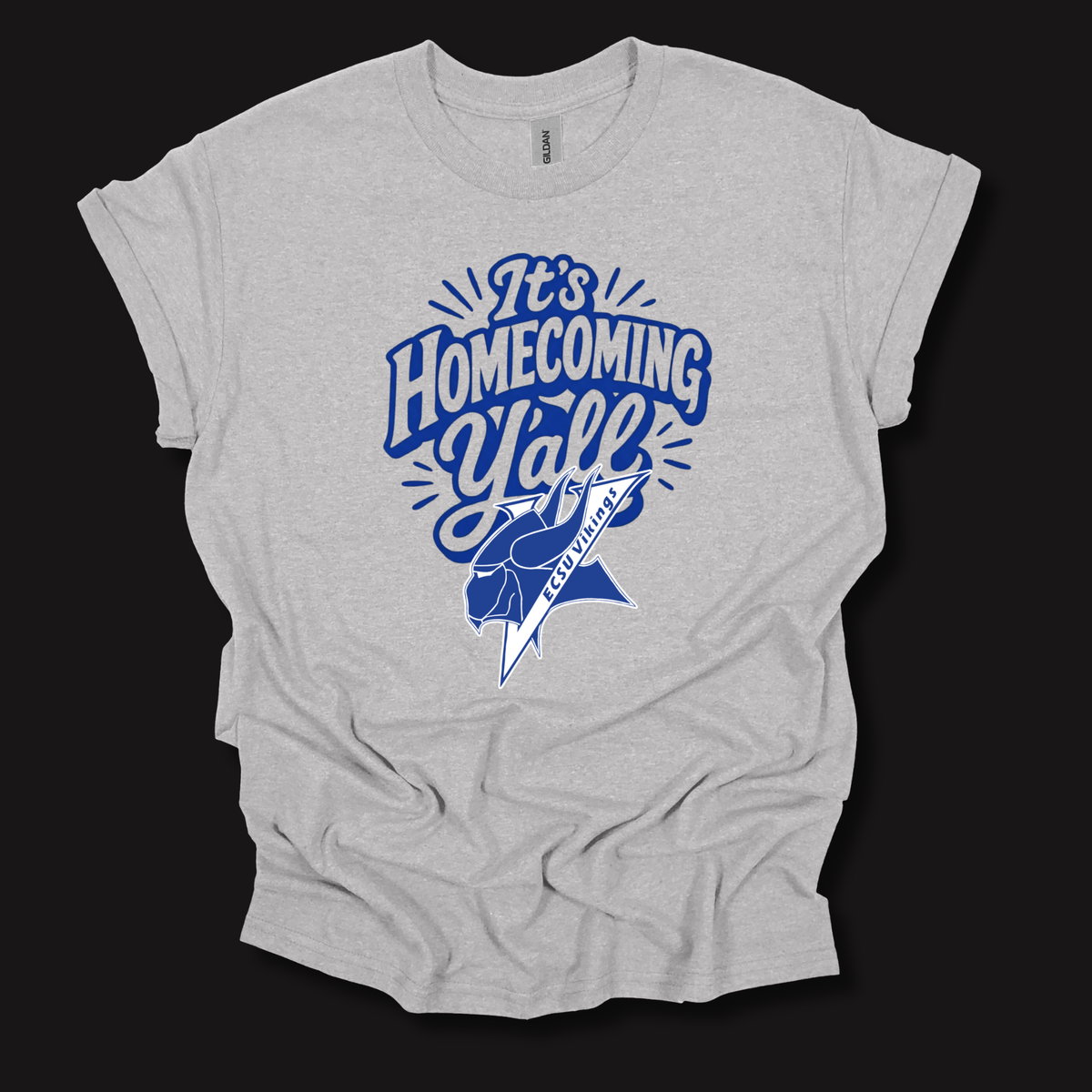 A light heather gray t-shirt with a blue graphic that reads 'It's Homecoming Yell' and a football player illustration, displayed on a solid black background.