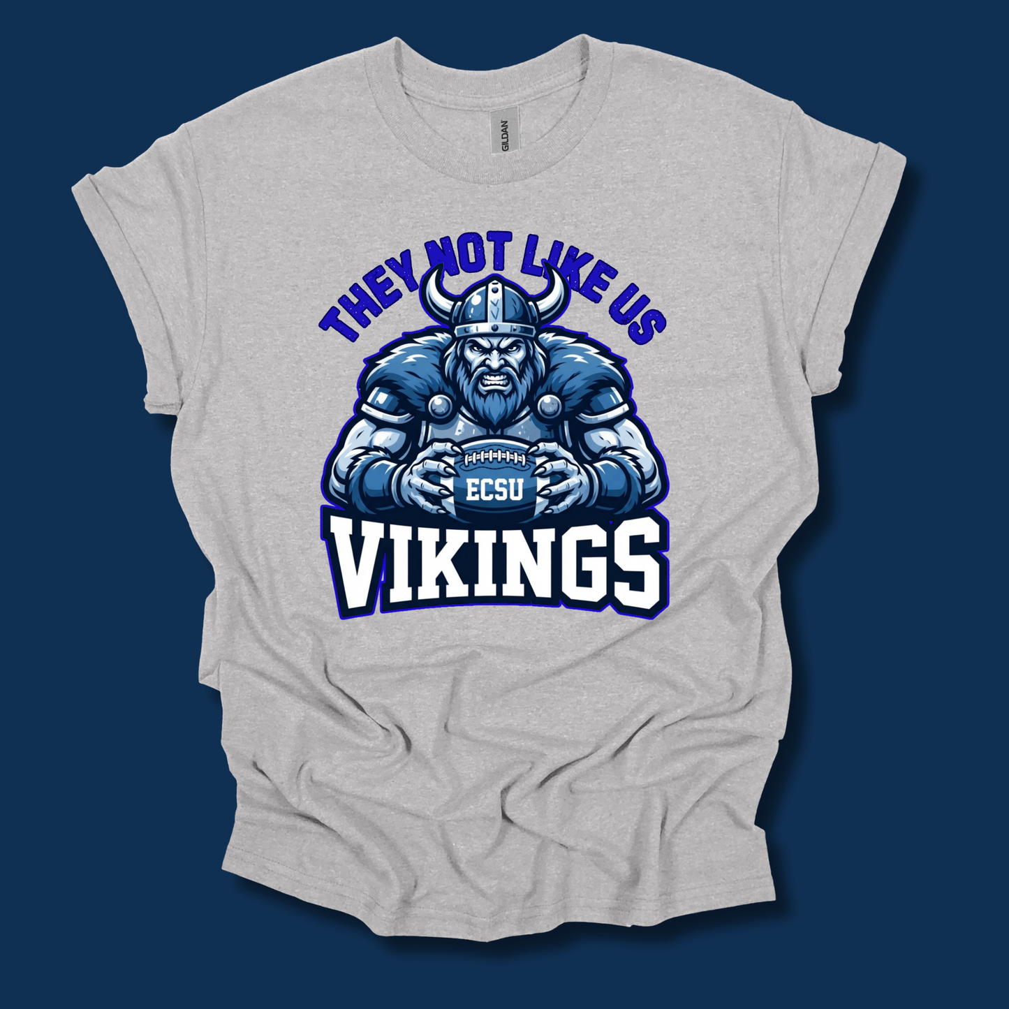 A light heather gray t-shirt with a graphic of a blue and white Viking football player and the text 'THEY NOT LIKE US VIKINGS' and 'ECSU', displayed on a dark blue background.