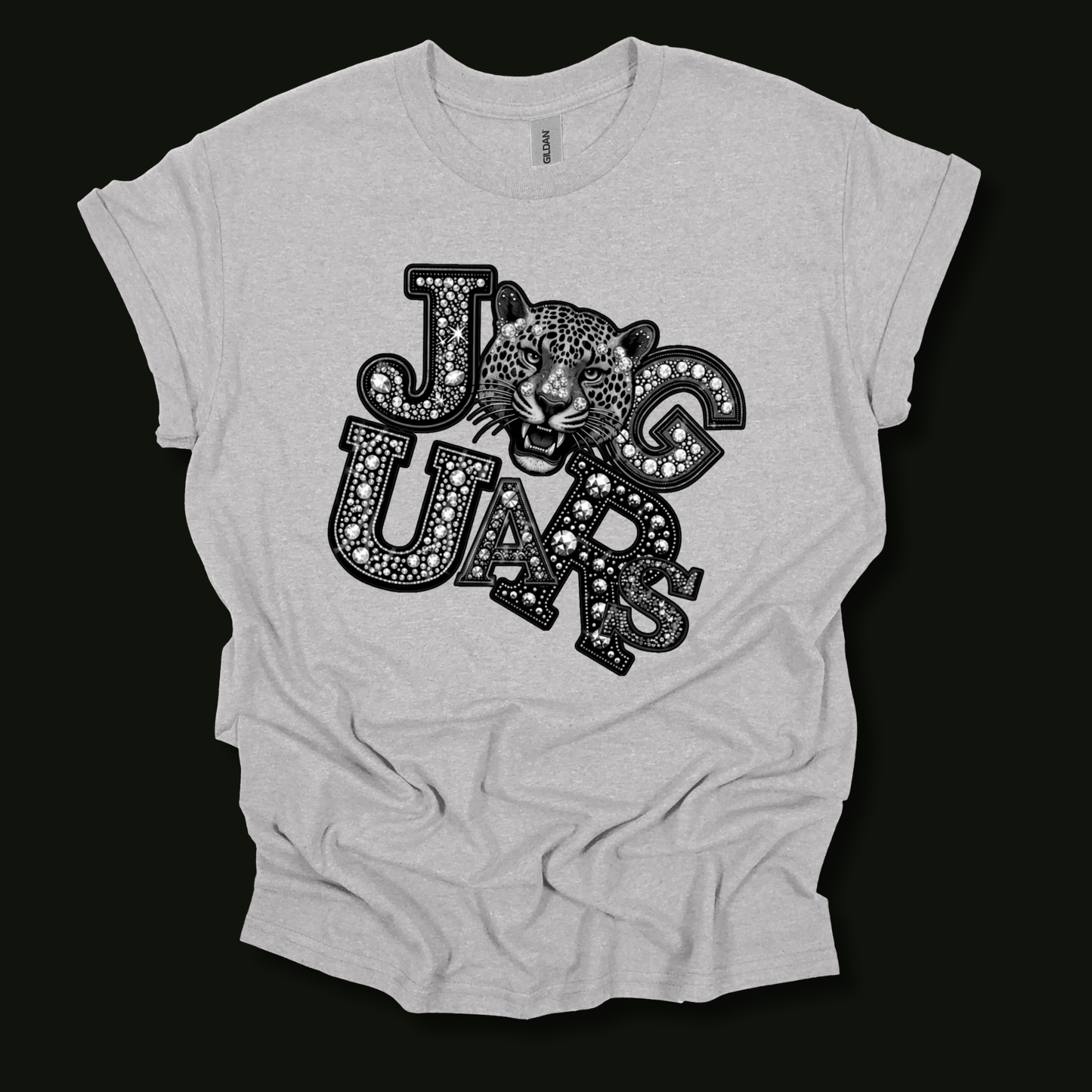 A light gray heather t-shirt with a graphic print of a jaguar and the word 'JAGUAR' in decorative black letters, displayed against a solid black background.
