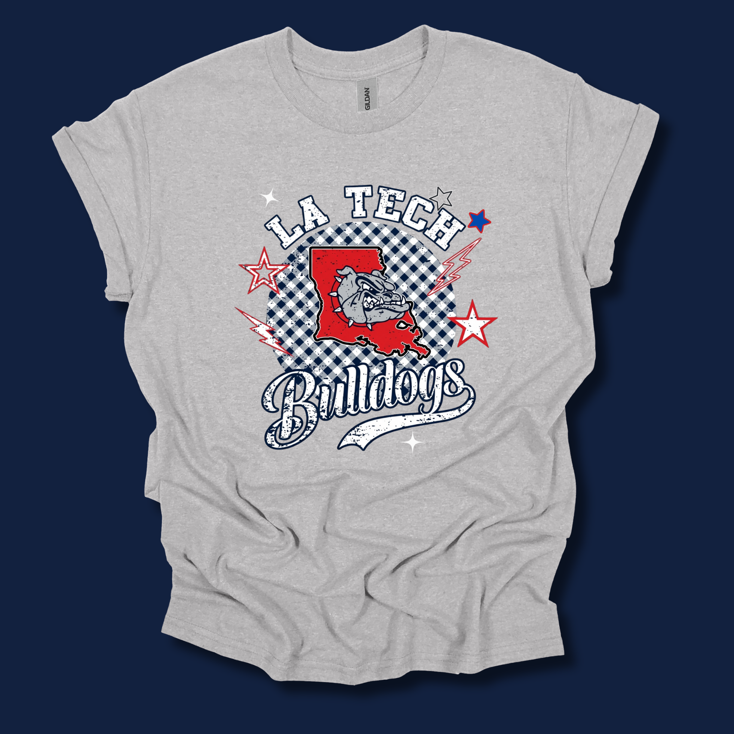 A light heather gray t-shirt with a 'LA Tech Bulldogs' graphic print on the front, displayed against a solid dark navy blue background.