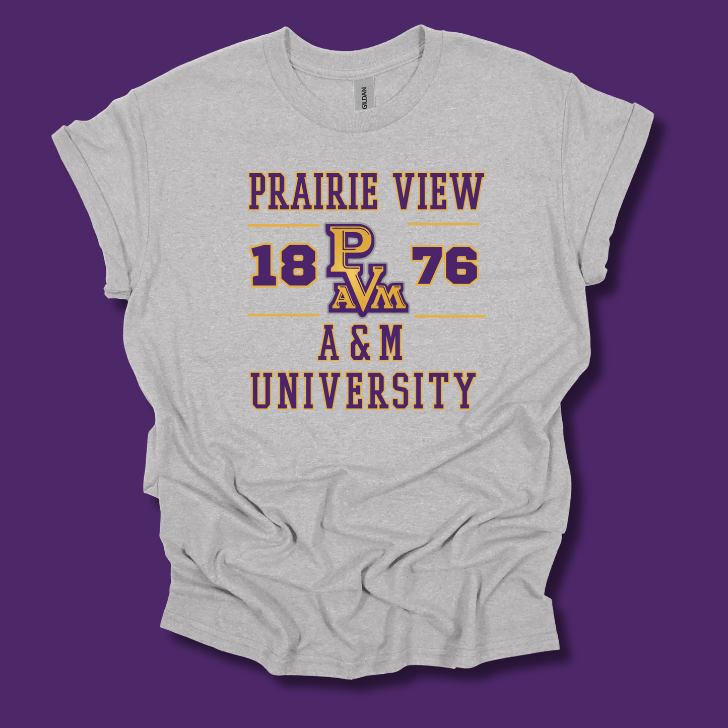 A light heather gray graphic t-shirt featuring the text 'PRAIRIE VIEW 18 PAV 76 A&M UNIVERSITY' in purple and maroon with gold outlines, displayed against a solid purple background.