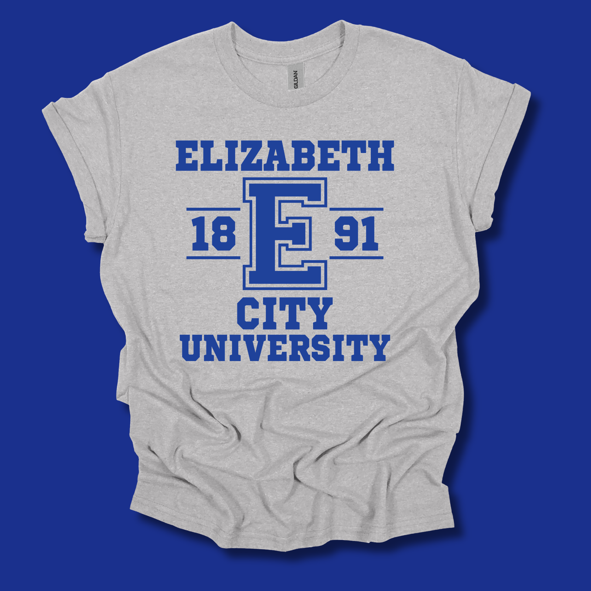 A light heather gray t-shirt with a blue graphic print reading 'ELIZABETH 18 E 91 CITY UNIVERSITY' on a solid blue background.