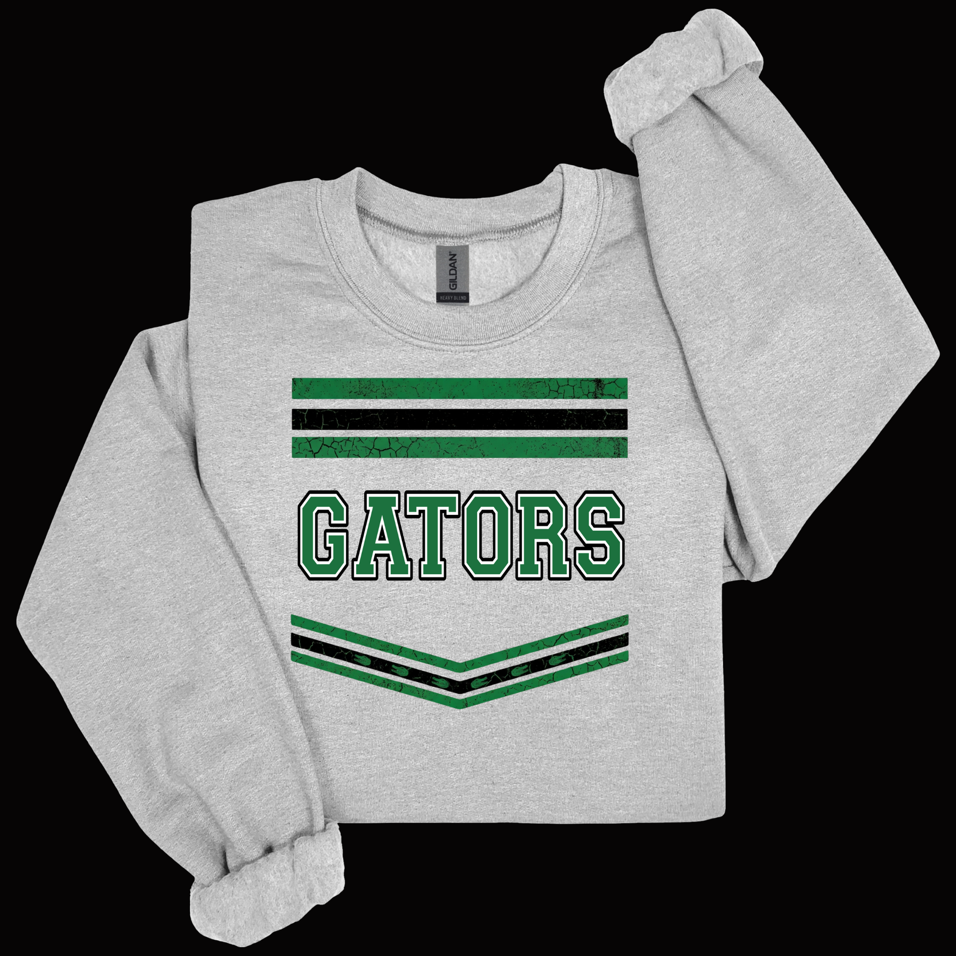 A light heather gray long-sleeve sweatshirt with a distressed green and black graphic on the front featuring the word 'GATORS' and striped accents, displayed against a solid black background.