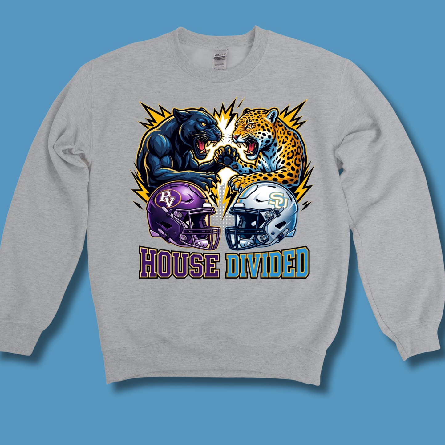 A heather gray crewneck sweatshirt featuring a large graphic print of a black panther and a leopard facing off, with purple and silver football helmets and the text 'HOUSE DIVIDED' underneath, displayed against a solid blue background.