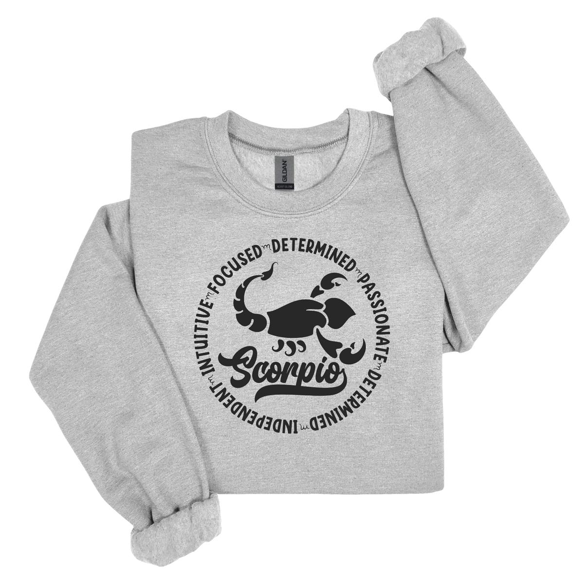 Woman wearing a grey crewneck sweatshirt featuring a white circular Scorpio zodiac graphic with a scorpion illustration, the word "Scorpio," and trait keywords like intuitive, focused, determined, passionate, and independent.