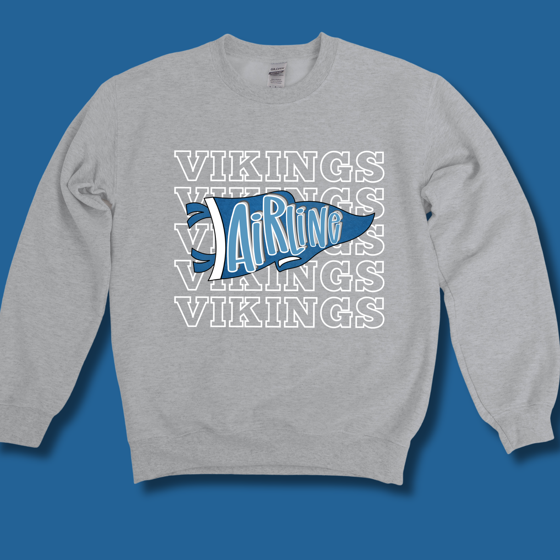 A heather gray crewneck sweatshirt featuring a blue and white graphic on the chest. The graphic displays a stylized blue pennant with the word 'Airline' in white script, layered over a repeating white outline pattern of the word 'VIKINGS'.