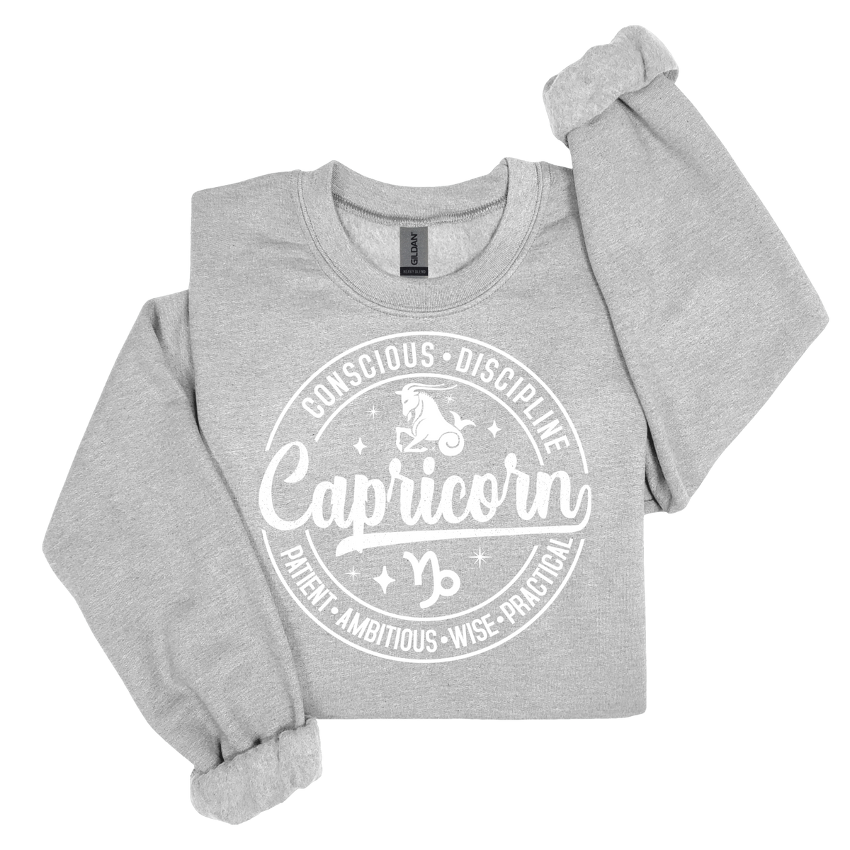 A light heather gray crewneck sweatshirt with rolled cuffs, featuring a white circular graphic on the front that reads 'Capricorn' with a zodiac symbol and the words 'Conscious Discipline'.