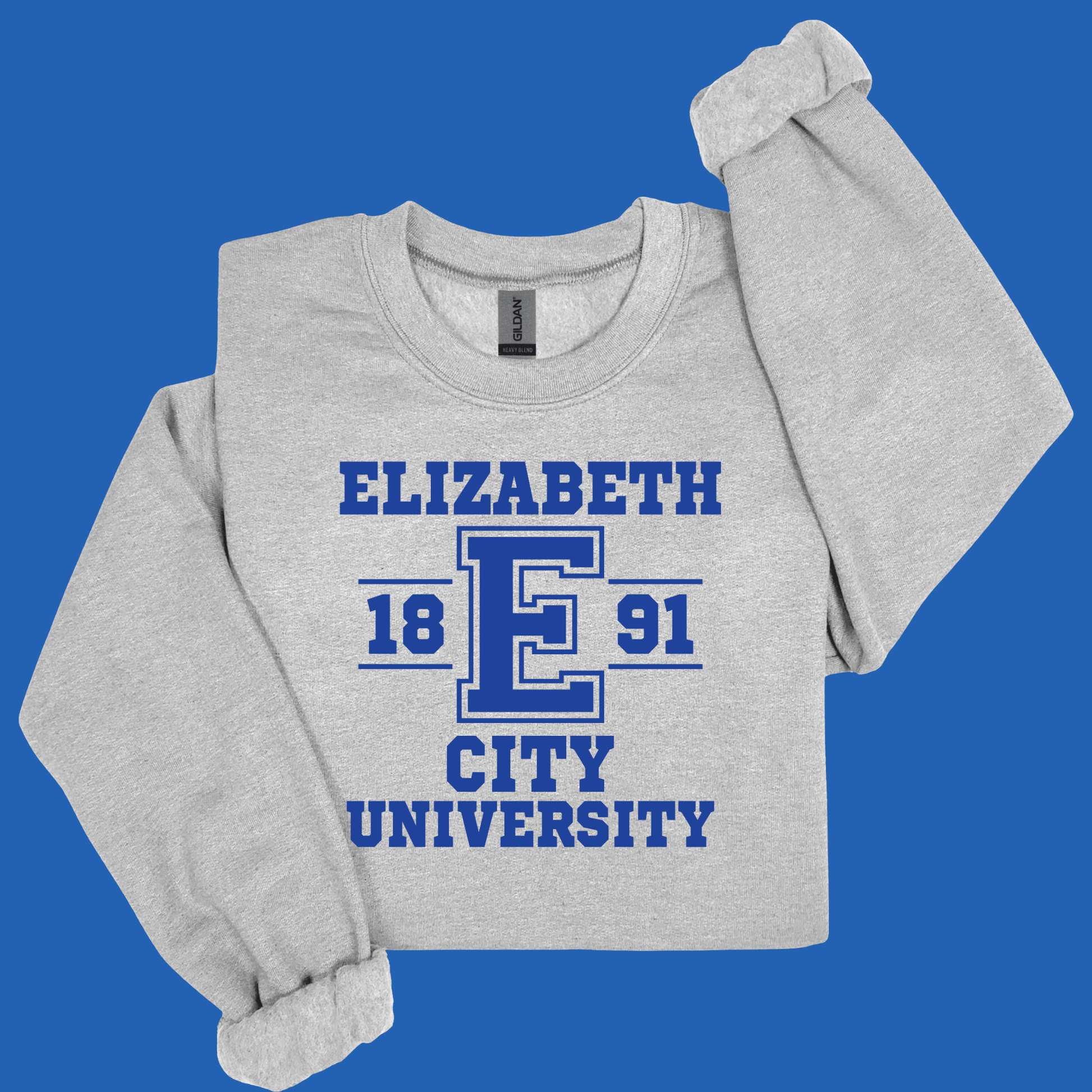 A light heather gray long-sleeve sweatshirt with a blue graphic print reading 'ELIZABETH 18 E 91 CITY UNIVERSITY' on the front, displayed against a solid blue background.