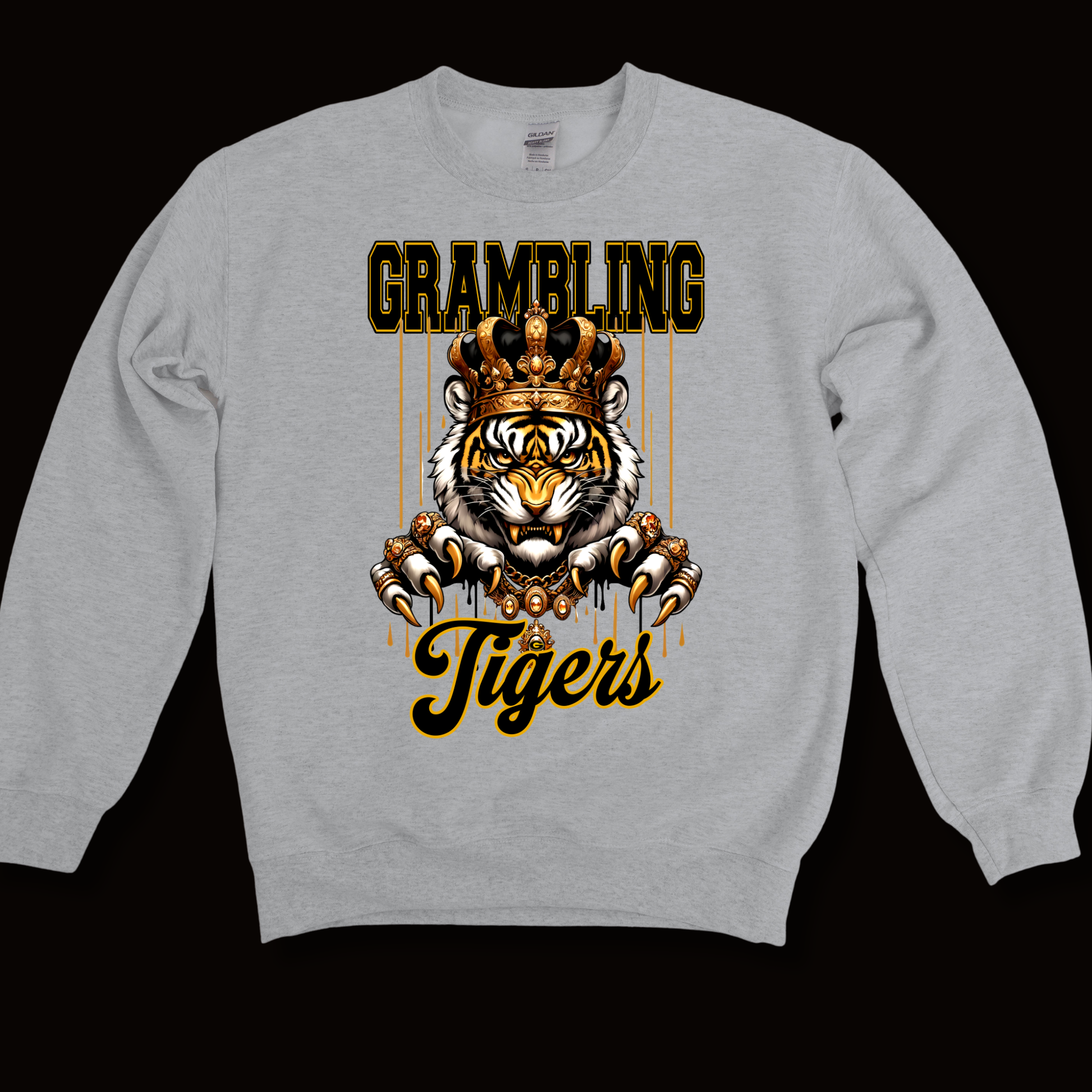 A light gray crewneck sweatshirt featuring a graphic print of a tiger wearing a crown, with the words 'GRAMBLING' above and 'Tigers' below in a gold and black stylized font, displayed against a solid black background.