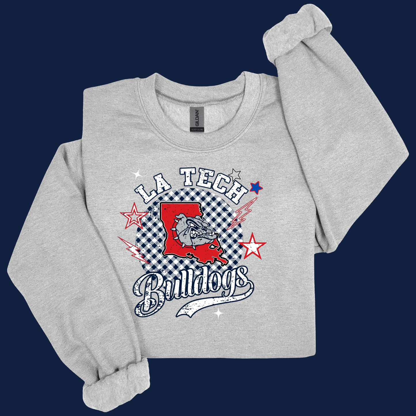 A light heather gray crewneck sweatshirt featuring a 'LA Tech Bulldogs' graphic on the front, styled with rolled cuffs and a folded sleeve against a dark navy blue background.