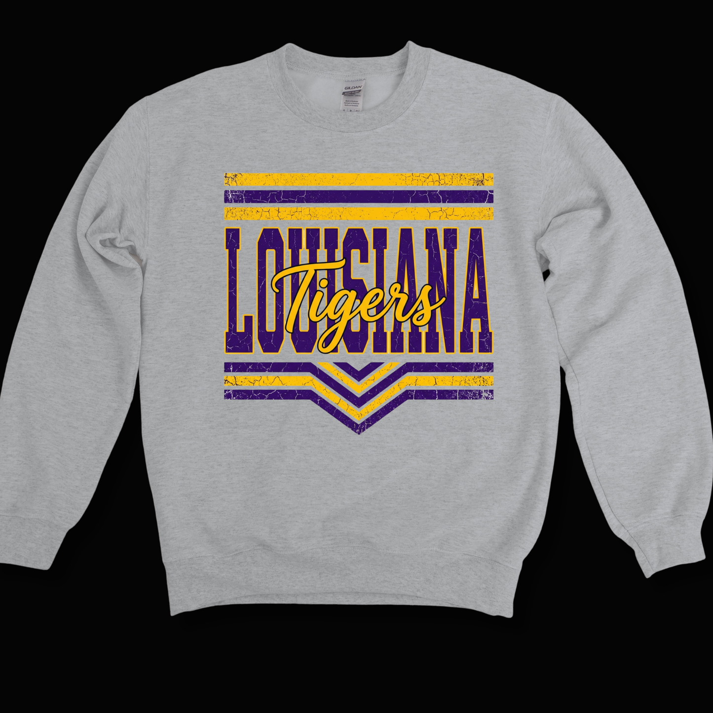 A light heather gray crewneck sweatshirt featuring a distressed purple and yellow graphic on the chest that reads 'LOUISIANA Tigers' with horizontal stripes and chevron details, shown against a solid black background.