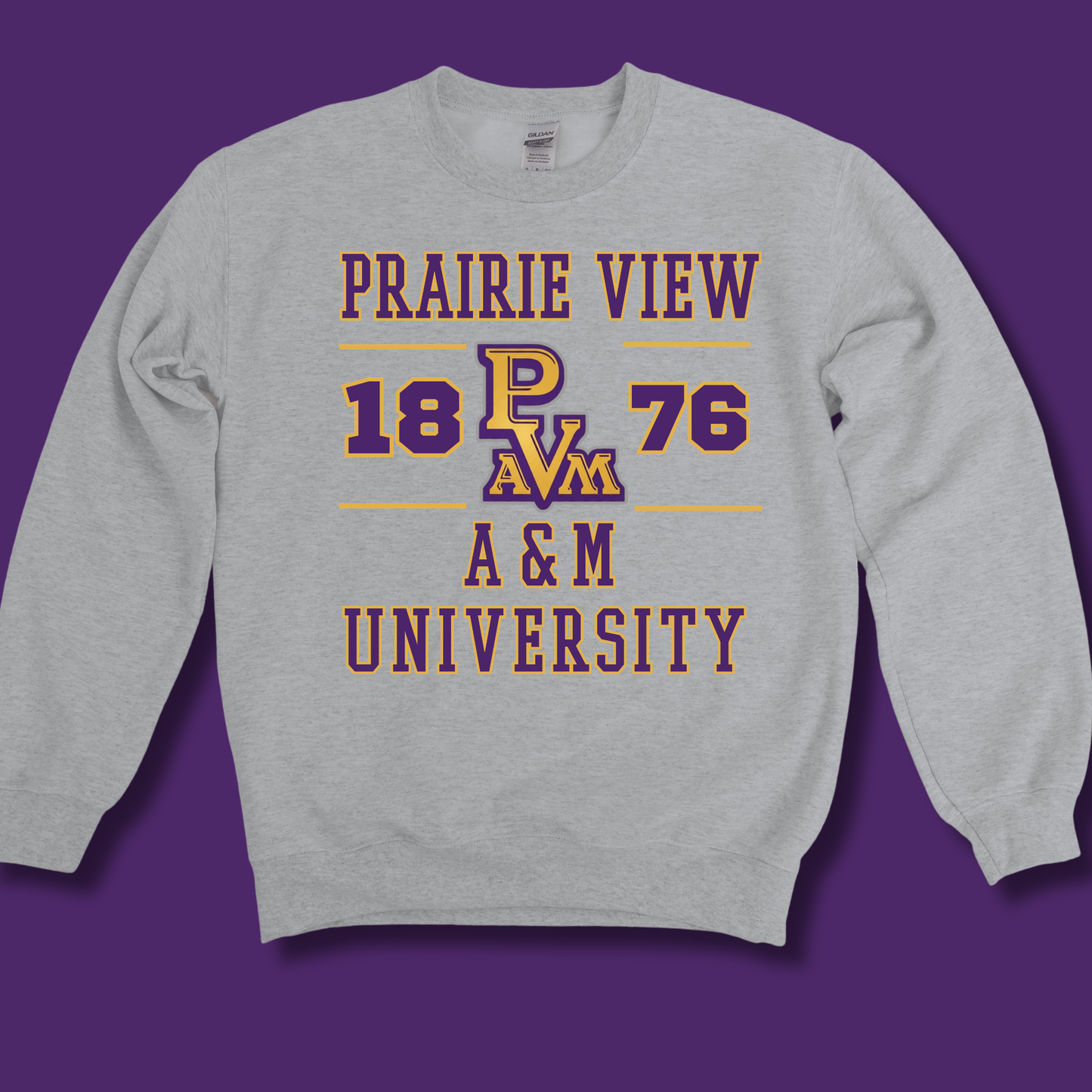 A light heather gray crewneck sweatshirt featuring a purple and gold graphic print that reads 'PRAIRIE VIEW 1876 A&M UNIVERSITY' with 'P A&M' in the center, displayed against a solid purple background.