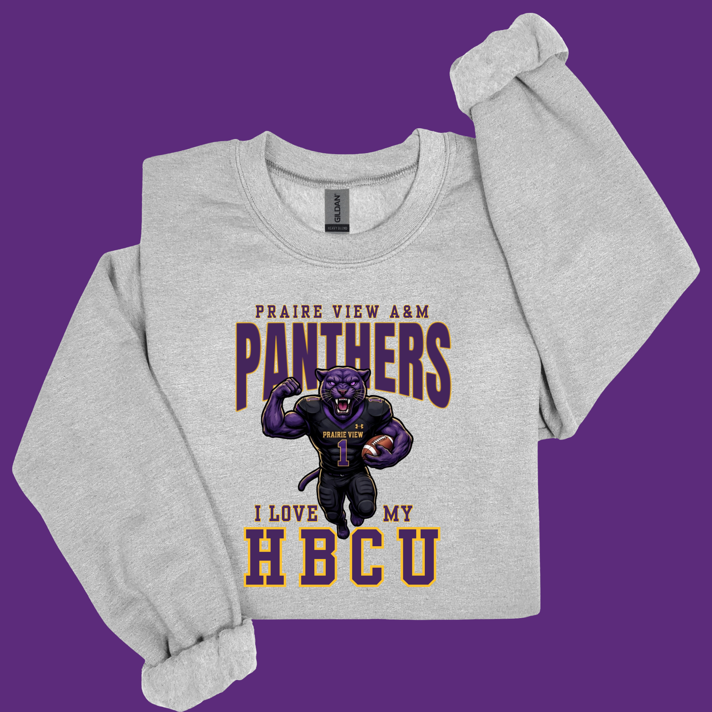 A light heather gray long-sleeve crewneck sweatshirt featuring a purple and gold graphic of a football-holding panther with the text 'PRAIRIE VIEW A&M PANTHERS' and 'I LOVE MY HBCU'. The sweatshirt is displayed flat against a solid purple background.