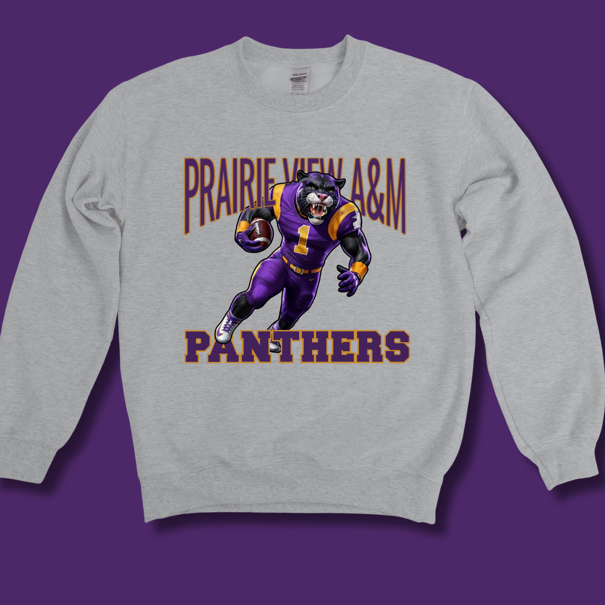A light gray crewneck sweatshirt featuring a graphic of a purple and gold football player with the text 'PRAIRIE VIEW A&M PANTHERS' on the front, displayed against a solid purple background.