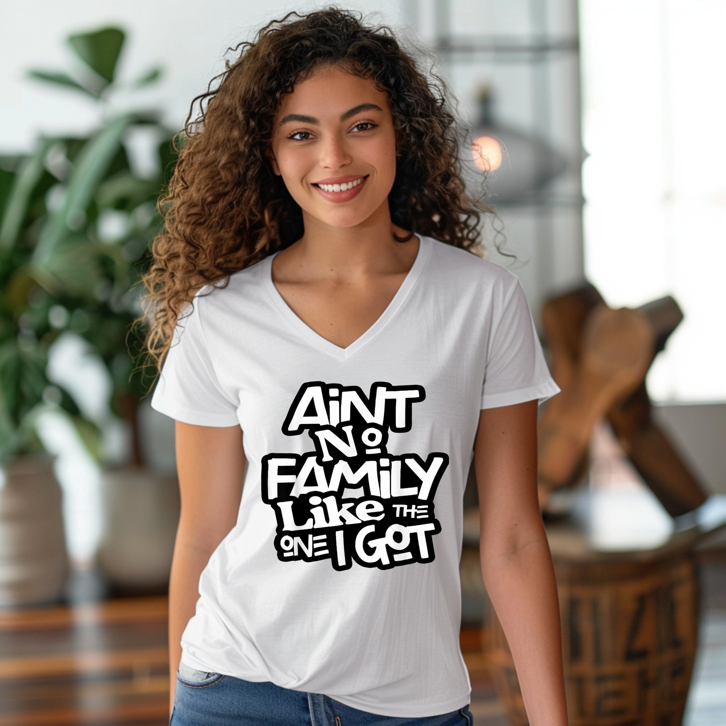 Woman wearing a white t-shirt with text in a casual indoor setting