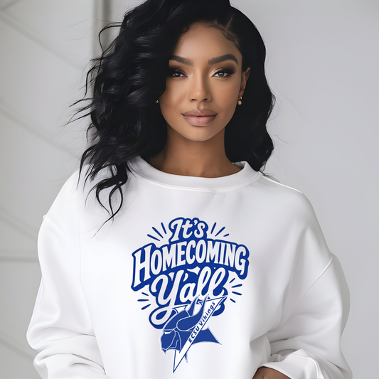 A woman wearing a white crewneck sweatshirt with a blue graphic that reads 'It's Homecoming Y'all' and 'Boyd League' with a football helmet illustration, set against a light gray background.