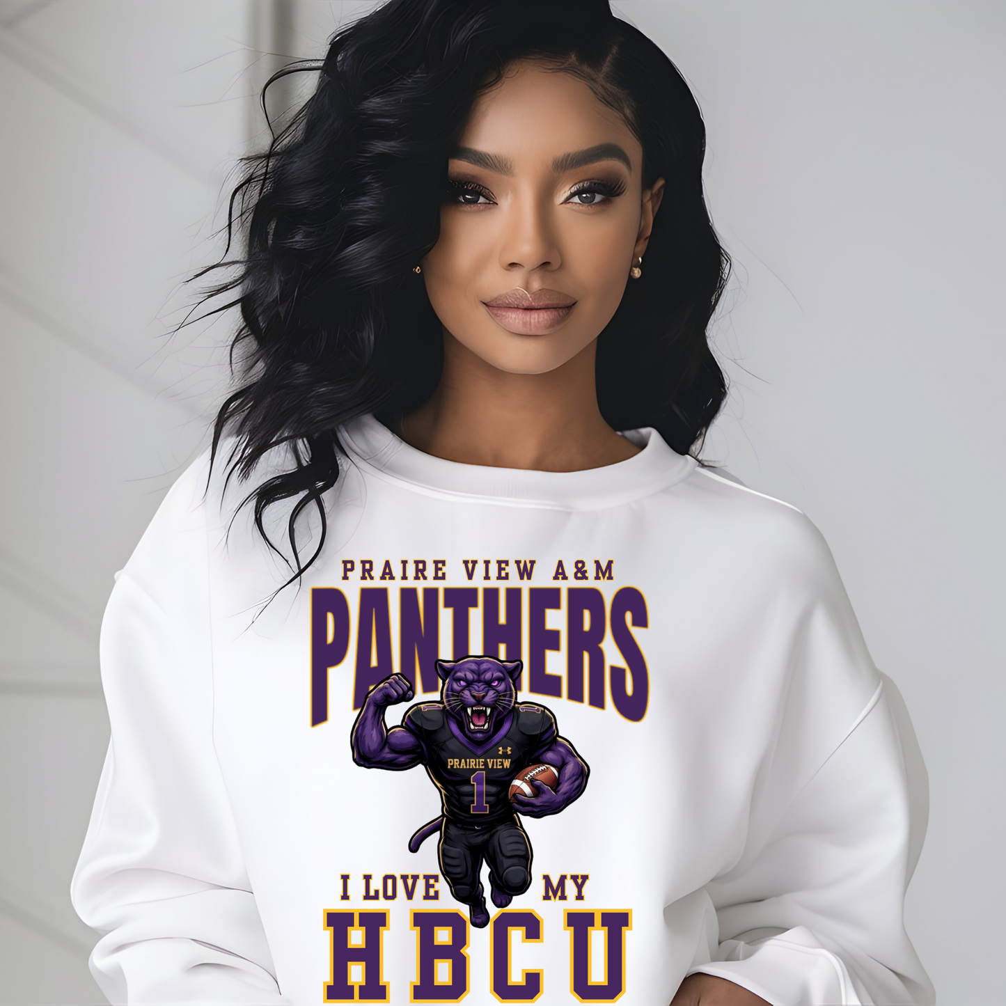 A woman wearing a white crewneck sweatshirt with a graphic print of a purple panther football player and the text 'PRAIRIE VIEW A&M PANTHERS I LOVE MY HBCU'.