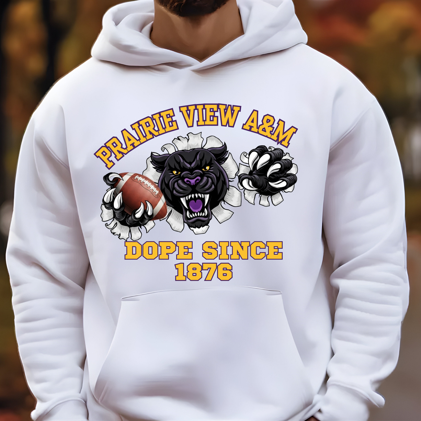 A white pullover hoodie worn by a model, featuring a graphic print of a black panther tearing through a football with the text 'PRAIRIE VIEW A&M' and 'DOPE SINCE 1876'.