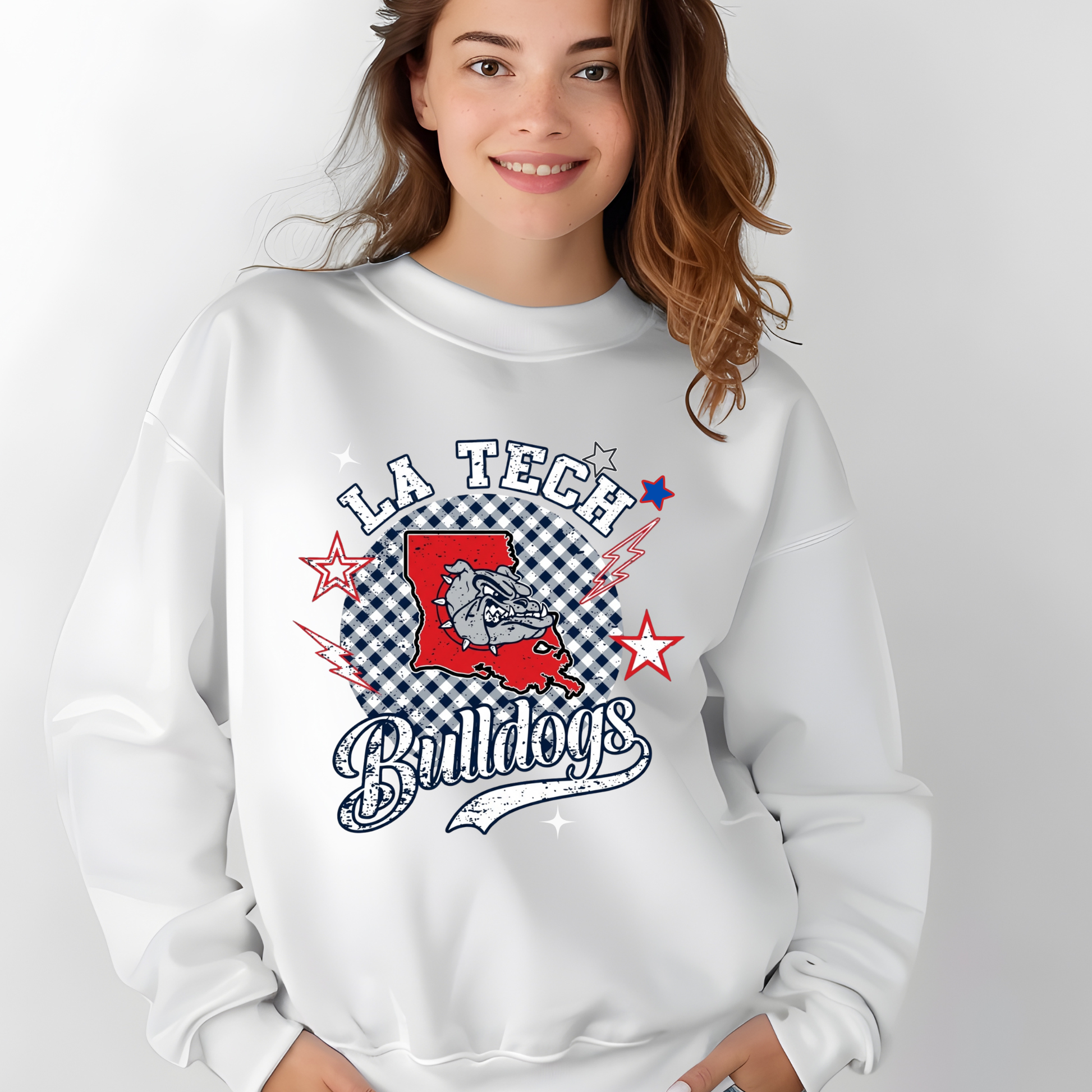 A woman wearing a white crewneck sweatshirt with a 'LA Tech Bulldogs' graphic on the front, set against a plain light gray background.