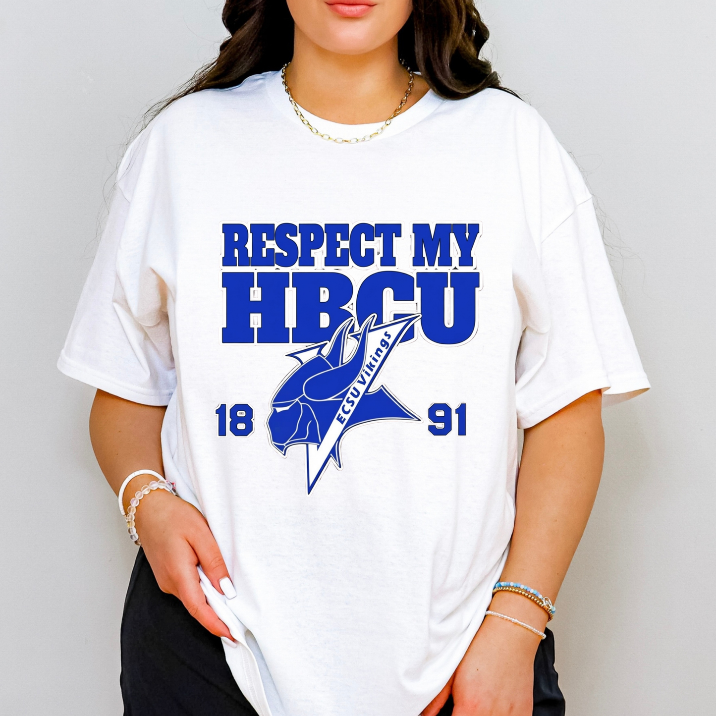 A woman wearing a white graphic t-shirt with blue text reading 'RESPECT MY HBCU' and '1891' with a blue fish logo, shown against a light gray background.